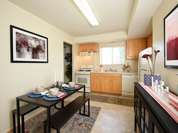Fully equipped kitchen with dishwasher, refrigerator and stove at arbuta arms apartments